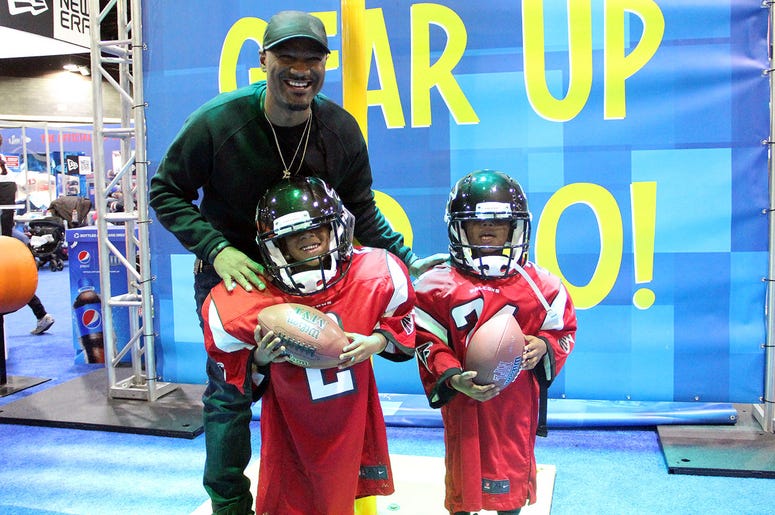 Big Tigger with kids in oversized Falcons uniforms Big Tigger with kids in oversized Falcons uniforms