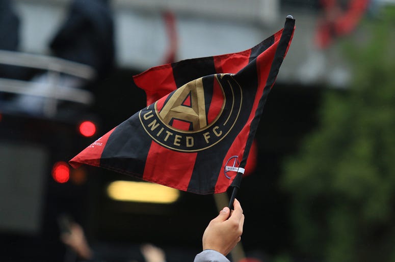 An Atlanta United fan waves the team flag during MLS Cup victory parade An Atlanta United fan waves the team flag during MLS Cup victory parade