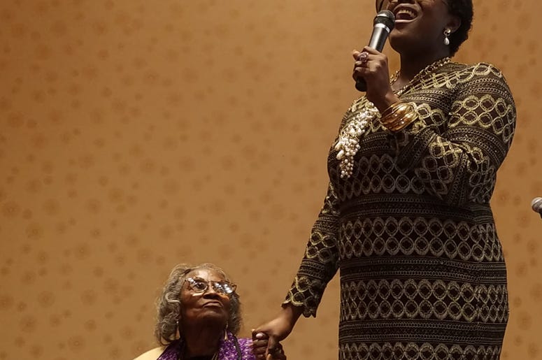 Mrs. Juanita Abernathy is serenaded by singer Nia Sadé Akinyemi during an awards ceremony in February 2019 Mrs. Juanita Abernathy is serenaded by singer Nia Sadé Akinyemi during an awards ceremony in February 2019