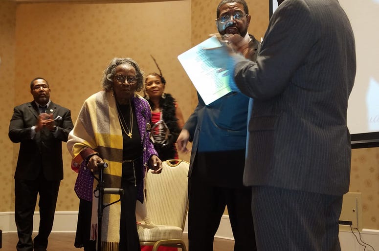 Mrs. Juanita Abernathy walks across the stage to accept an award in February 2019 Mrs. Juanita Abernathy walks across the stage to accept an award in February 2019