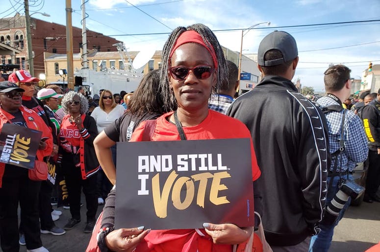 An attendee is shown at the 55 year observance of the March for Voter Rights in Selma, ALhts in An attendee is shown at the 55 year observance of the March for Voter Rights in Selma, ALhts in