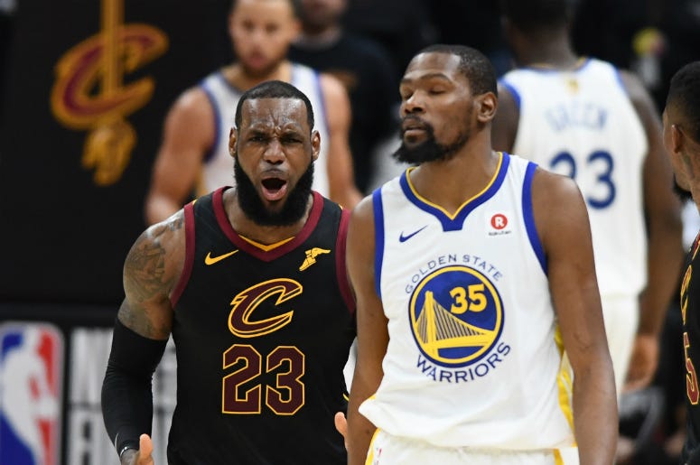 Lebron James & Kevin Durant Jun 6, 2018; Cleveland, OH, USA; Cleveland Cavaliers forward LeBron James (23) reacts as Golden State Warriors forward Kevin Durant (35) looks on during the second quarter in game three of the 2018 NBA Finals at Quicken Loans Arena.