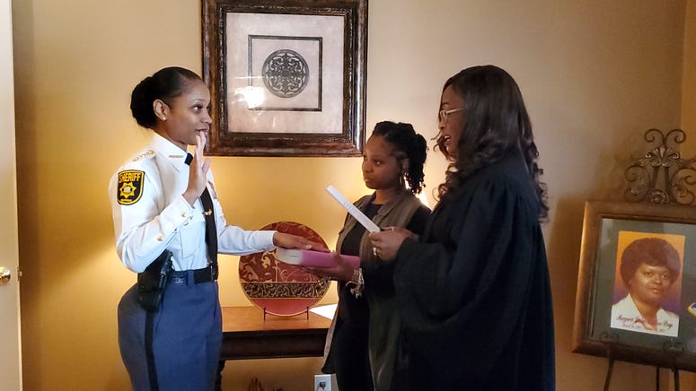 Melody Maddox is sworn in as sheriff by DeKalb Superior Court Judge LaTisha Dear Jackson as Maddox's daughter Indira Woodward looks on Melody Maddox is sworn in as sheriff by DeKalb Superior Court Judge LaTisha Dear Jackson as Maddox's daughter Indira Woodward looks on