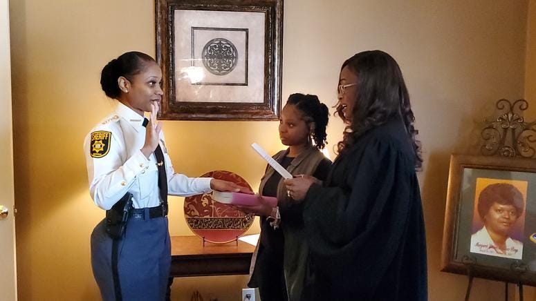 Melody Maddox is sworn in as sheriff by DeKalb Superior Court Judge LaTisha Dear Jackson as Maddox's daughter Indira Woodward looks on Melody Maddox is sworn in as sheriff by DeKalb Superior Court Judge LaTisha Dear Jackson as Maddox's daughter Indira Woodward looks on