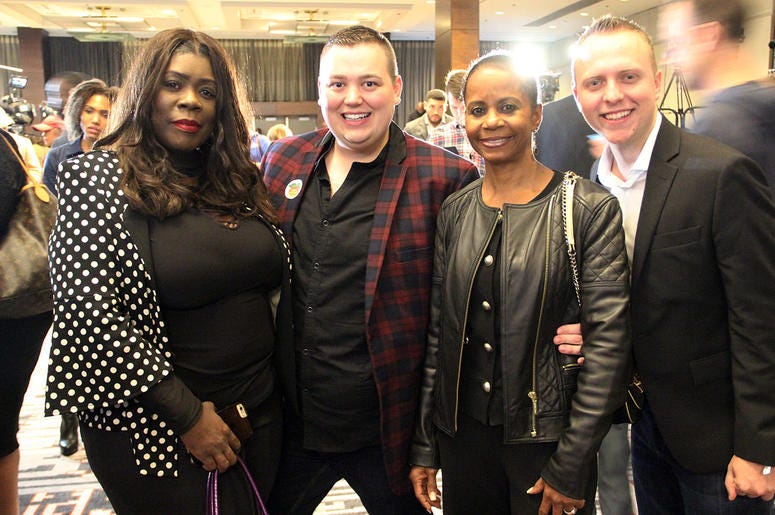 A group of smiling attendees at Stacey Abrams' election night campaign party A group of smiling attendees at Stacey Abrams' election night campaign party