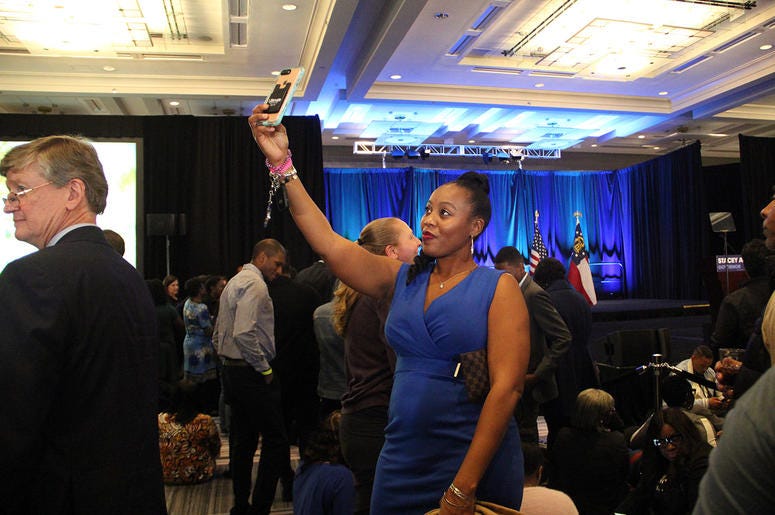 A lady takes a selfie at Stacey Abrams' election night campaign party A lady takes a selfie at Stacey Abrams' election night campaign party