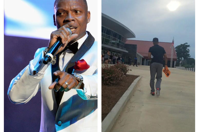 Singer Ron Devoe walks to Monday's community forum on toxic air carrying orange protest sign. Singer Ron Devoe walks to Monday's community forum on toxic air carrying orange protest sign.