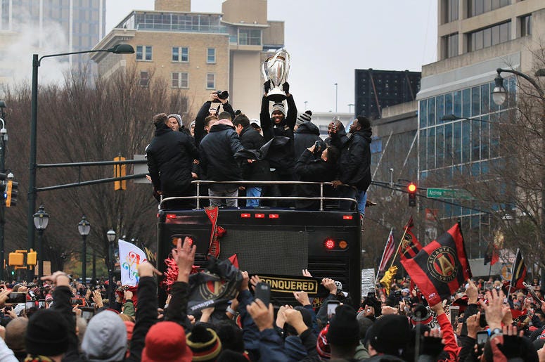 Atlanta United team members celebrate during victory parade Atlanta United team members celebrate during victory parade