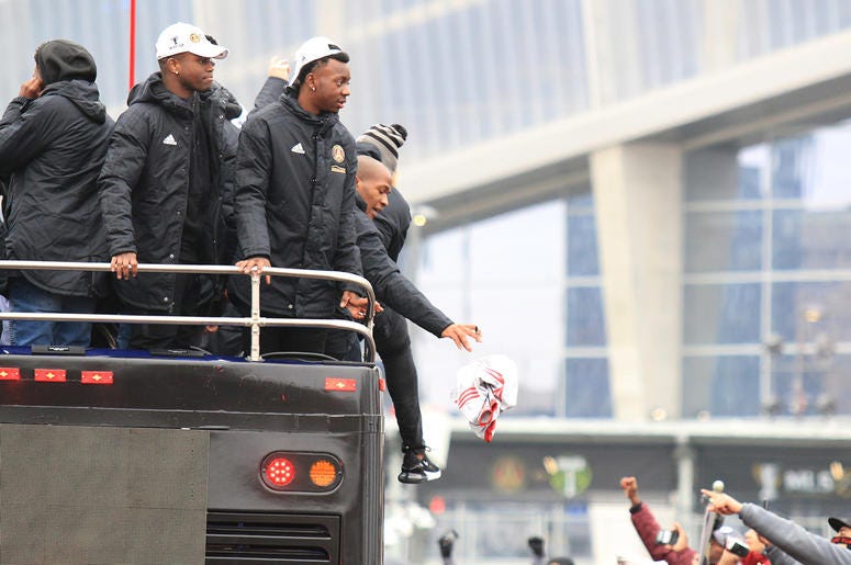 Atlanta United team members throw gifts to fans during victory parade Atlanta United team members throw gifts to fans during victory parade