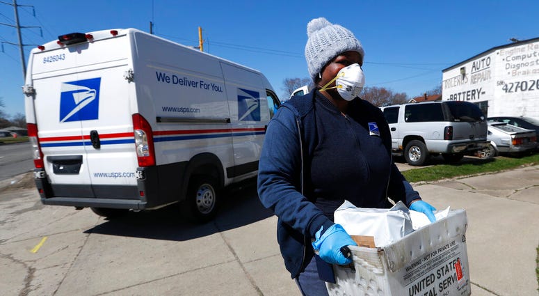 United States Postal Service worker makes a delivery United States Postal Service worker makes a delivery
