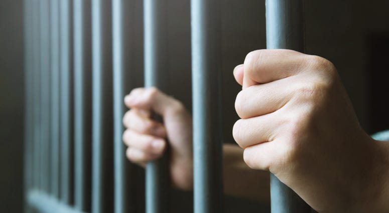 inmate behind bars inmate behind bars