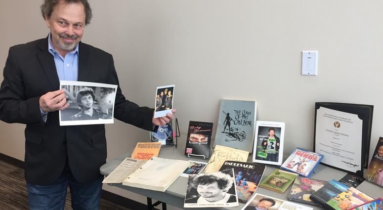 Curtis Armstrong shows off items from his collection