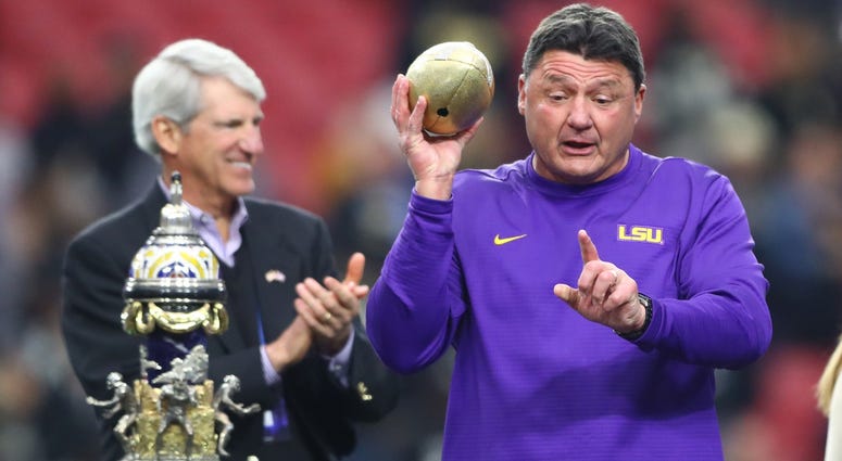 Jan 1, 2019; Glendale, AZ, USA; LSU Tigers head coach Ed Orgeron celebrates wit the trophy after defeating the UCF Knights in the 2019 Fiesta Bowl at State Farm Stadium.