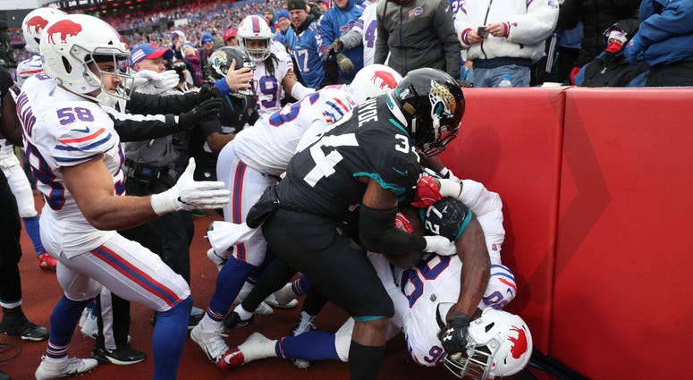 Buffalo Bills' Shaq Lawson fights with Jacksonville's Leonard Fournette. Both players were ejected during the fight.