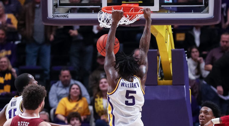 Jan 29, 2020; Baton Rouge, Louisiana, USA; LSU Tigers forward Emmitt Williams (5) dunks the ball against Alabama Crimson Tide forward Herbert Jones (1) in the second half at Maravich Assembly Center. LSU basketball