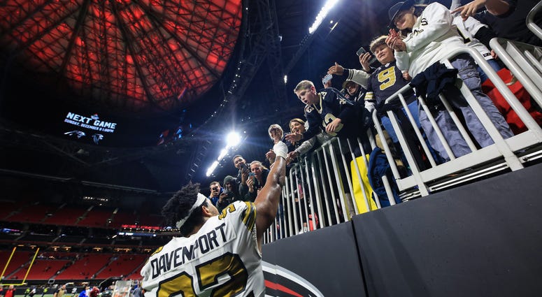 ATLANTA, GA - NOVEMBER 28: Marcus Davenport #92 of the New Orleans Saints hands a turkey leg to fans following the game against the Atlanta Falcons at Mercedes-Benz Stadium. New Orleans Saints won against Atlanta Falcons 23-18. New Orleans Saints Mercedes-Benz Stadium Atlanta