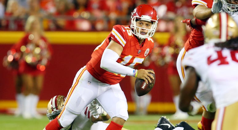 Kansas City Chiefs quarterback Patrick Mahomes II (15) evades San Francisco 49ers defensive lineman Solomon Thomas (94) in the second half at Arrowhead Stadium.