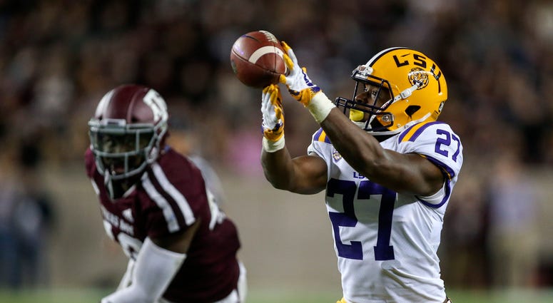 LSU Tigers running back Lanard Fournette (27) is unable to make a reception as Texas A&M Aggies linebacker Otaro Alaka (42) defends during the third quarter at Kyle Field.