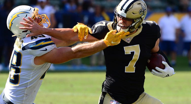 Aug 18, 2019; Carson, CA, USA; New Orleans Saints quarterback Taysom Hill (7) stiff arms Los Angeles Chargers linebacker Nick Dzubnar (48) during the fourth quarter at Dignity Health Sports Park. Aug 18, 2019; Carson, CA, USA; New Orleans Saints quarterback Taysom Hill (7) stiff arms Los Angeles Chargers linebacker Nick Dzubnar (48) during the fourth quarter at Dignity Health Sports Park.
