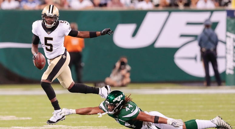 Aug 24, 2019; East Rutherford, NJ, USA; New Orleans Saints quarterback Teddy Bridgewater (5) scrambles for yards as New York Jets linebacker Harvey Langi (44) defends during the first half at MetLife Stadium. Aug 24, 2019; East Rutherford, NJ, USA; New Orleans Saints quarterback Teddy Bridgewater (5) scrambles for yards as New York Jets linebacker Harvey Langi (44) defends during the first half at MetLife Stadium.
