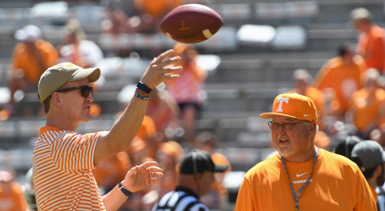 NFL former quarterback Peyton Manning and Tennessee Volunteers equipment manager Roger Frazier speak prior to the game against the Georgia State Panthers at Neyland Stadium.