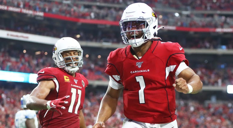 Arizona Cardinals quarterback Kyler Murray (1) and wide receiver Larry Fitzgerald (11) celebrate a game tying two point conversion in the fourth quarter against the Detroit Lions at State Farm Stadium.