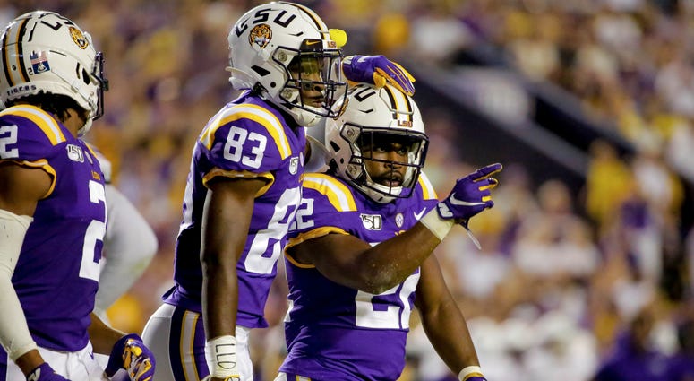 LSU Tigers running back Clyde Edwards-Helaire (22) celebrates with wide receiver Jaray Jenkins (83) during the second quarter against the Northwestern State Demons at Tiger Stadium.