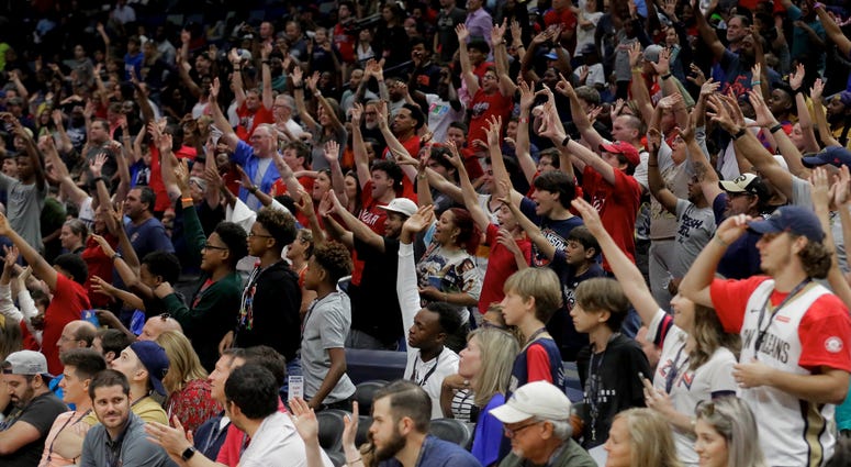 New Orleans Pelicans fans cheer during a open practice at the Smoothie King Center.