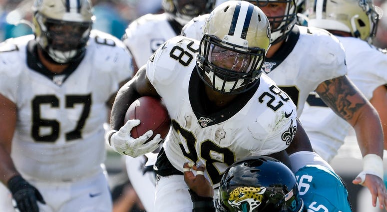 New Orleans Saints running back Latavius Murray (28) runs the ball against Jacksonville Jaguars defensive tackle Marcell Dareus (99) during the fourth quarter at TIAA Bank Field.