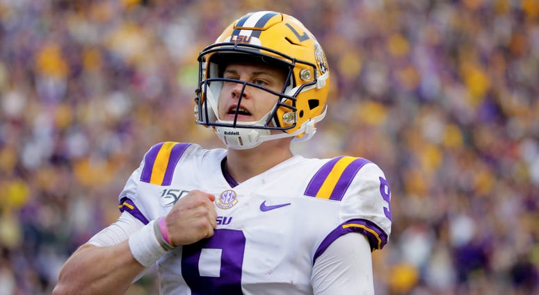 LSU Tigers quarterback Joe Burrow (9) celebrates after running for a touchdown during the fourth quarter against the Auburn Tigers at Tiger Stadium.