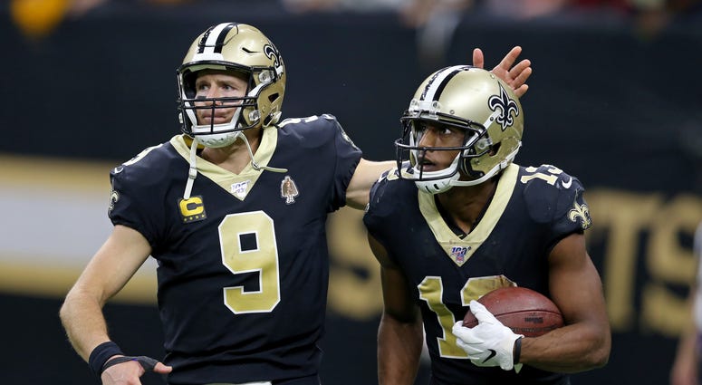 New Orleans Saints wide receiver Michael Thomas (13) celebrates with quarterback Drew Brees (9) after making a fourth quarter touchdown catch against the Arizona Cardinals at the Mercedes-Benz Superdome.