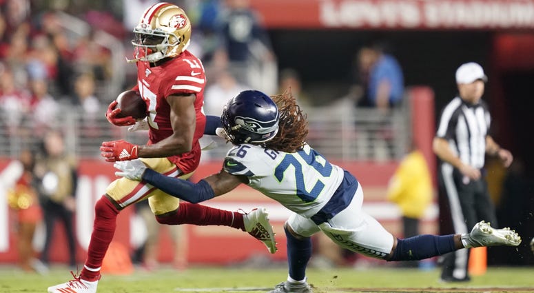 San Francisco 49ers wide receiver Emmanuel Sanders (17) is tackled by Seattle Seahawks cornerback Shaquill Griffin (26) during the first quarter at Levi's Stadium.