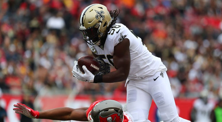 New Orleans Saints outside linebacker Demario Davis (56) intercepts a pass against Tampa Bay Buccaneers tight end O.J. Howard (80) during the first half at Raymond James Stadium.