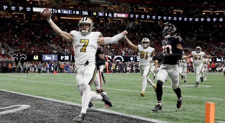 New Orleans Saints quarterback Taysom Hill (7) scores a rushing touchdown in the second quarter against the Atlanta Falcons at Mercedes-Benz Stadium.