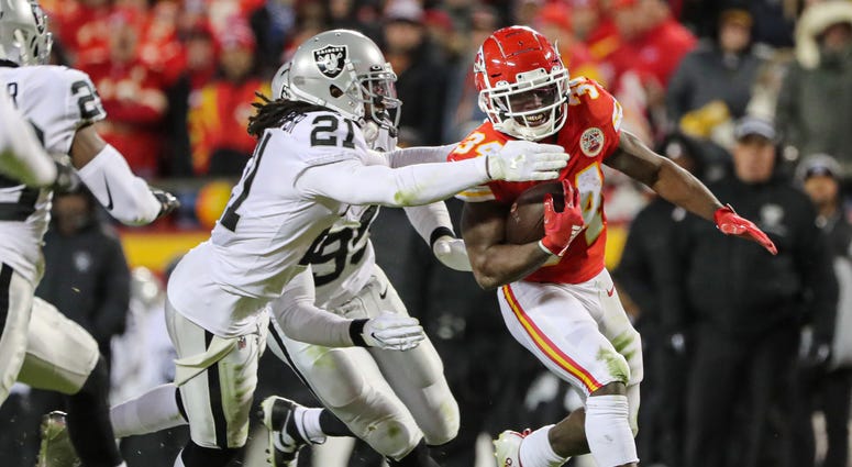 Kansas City Chiefs running back Darwin Thompson (34) runs against Oakland Raiders free safety D.J. Swearinger (21) during the second half at Arrowhead Stadium.
