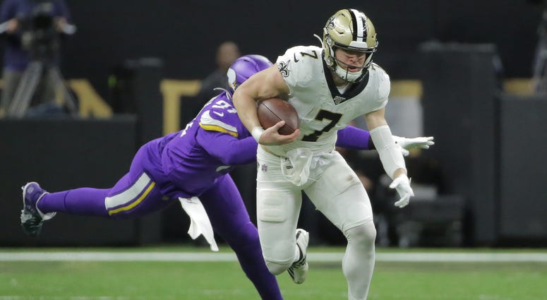New Orleans Saints quarterback Taysom Hill (7) runs the ball against the Minnesota Vikings during the second quarter of a NFC Wild Card playoff football game at the Mercedes-Benz Superdome.