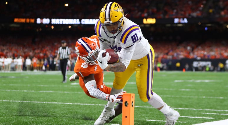 LSU Tigers tight end Thaddeus Moss (81) scores a touchdown past Clemson Tigers cornerback Derion Kendrick (1) in the third quarter in the College Football Playoff national championship game at Mercedes-Benz Superdome.