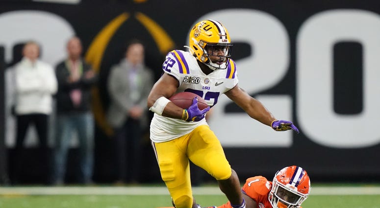 LSU Tigers running back Clyde Edwards-Helaire (22) runs past Clemson Tigers cornerback Derion Kendrick (1) in the fourth quarter in the College Football Playoff national championship game at Mercedes-Benz Superdome.