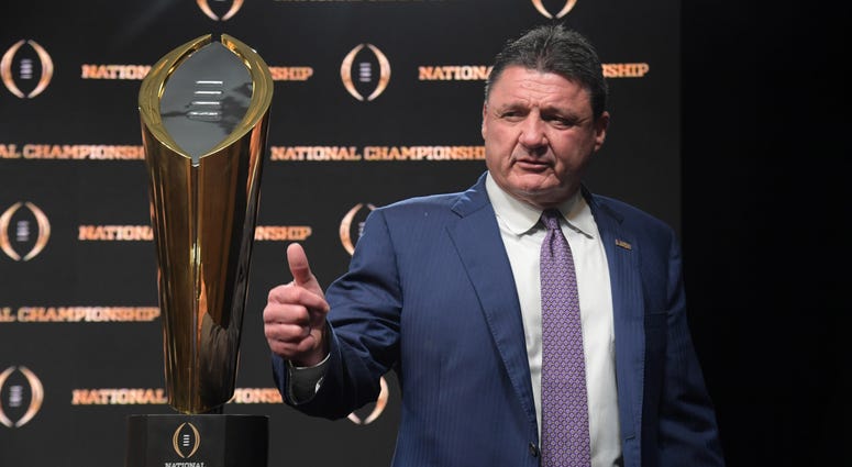 LSU Tigers coach Ed Orgeron poses with trophy during the CFP National Championship champions press conference at the Sheraton New Orleans. LSU defeated Clemson 42-25.
