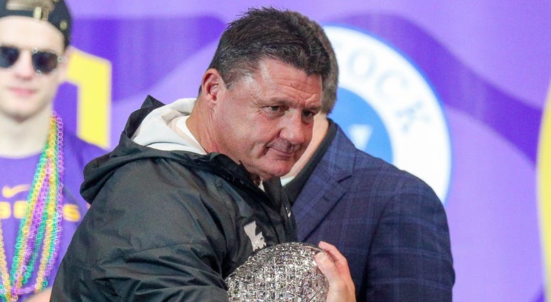 LSU Tigers head coach Ed Orgeron holds the AFCA Coaches' Trophy presented by Amway during the LSU championship trophy presentation at Pete Maravich Assembly Center. Stephen Lew-USA TODAY Sports