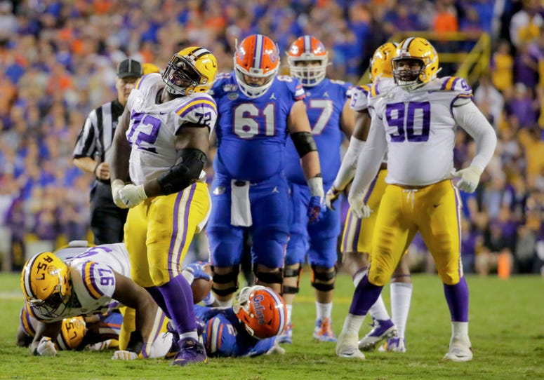 LSU Tigers nose tackle Tyler Shelvin (72) celebrates after a defensive stop against the Florida Gators during the second half at Tiger Stadium.