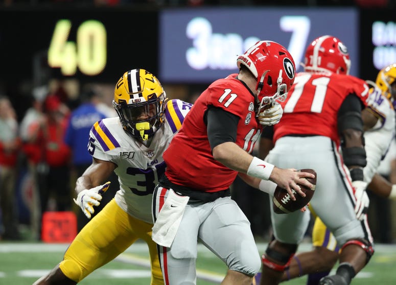 LSU Tigers linebacker Damone Clark (35) tackles Georgia Bulldogs quarterback Jake Fromm (11) in the first quarter in the 2019 SEC Championship Game at Mercedes-Benz Stadium.