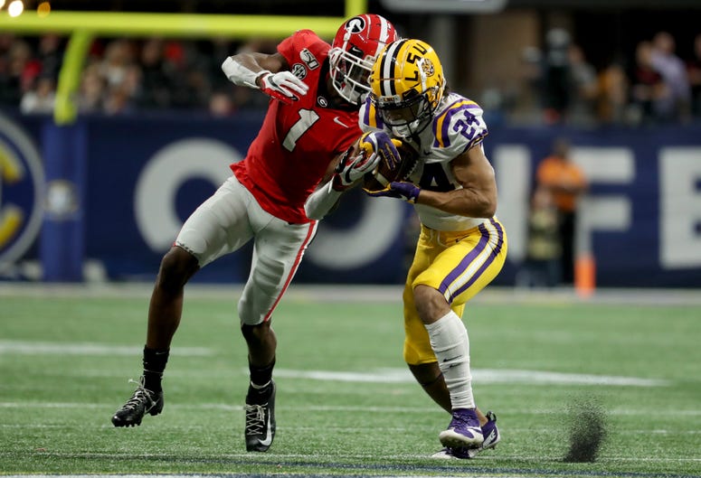 LSU Tigers cornerback Derek Stingley Jr. (24) intercepts a pass intended for Georgia Bulldogs wide receiver George Pickens (1) in the third quarter of the 2019 SEC Championship Game at Mercedes-Benz Stadium.