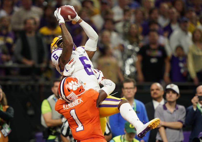 LSU Tigers wide receiver Terrace Marshall Jr. (6) makes a catch for a touchdown against Clemson Tigers cornerback Derion Kendrick (1) in the fourth quarter in the College Football Playoff national championship game at Mercedes-Benz Superdome.