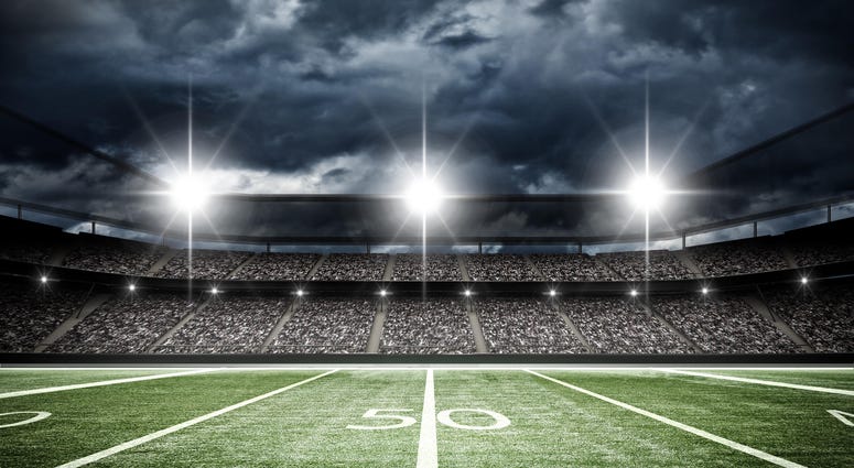 A football field under stadium lights
