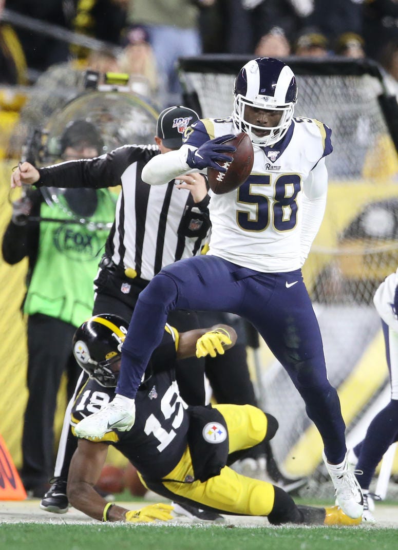 Pittsburgh Steelers wide receiver JuJu Smith-Schuster (19) forces Los Angeles Rams inside linebacker Cory Littleton (58) out of bounds after Littleton recovered a fumble during the second quarter at Heinz Field.