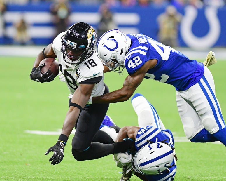 Indianapolis Colts safety Rolan Milligan (42) and cornerback Marvell Tell III (39) tackle Jacksonville Jaguars receiver Chris Conley (18) in the second half at Lucas Oil Stadium.