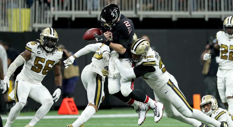 Atlanta Falcons quarterback Matt Ryan (2) fumbles the ball as he is hit by New Orleans Saints cornerback Marshon Lattimore (23) and defensive end Marcus Davenport (92) in the second half at Mercedes-Benz Stadium.