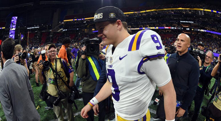 LSU Tigers quarterback Joe Burrow (9) walks across the field as they celebrate their 37-10 victory over the Georgia Bulldogs in the 2019 SEC Championship Game at Mercedes-Benz Stadium.