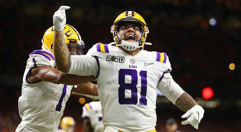 LSU Tigers tight end Thaddeus Moss (81) celebrates after scoring a touchdown against the Clemson Tigers in the third quarter in the College Football Playoff national championship game at Mercedes-Benz Superdome.